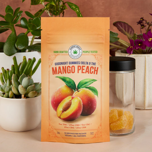 Mango peach gummy package with plants and a jar of gummies in the background
